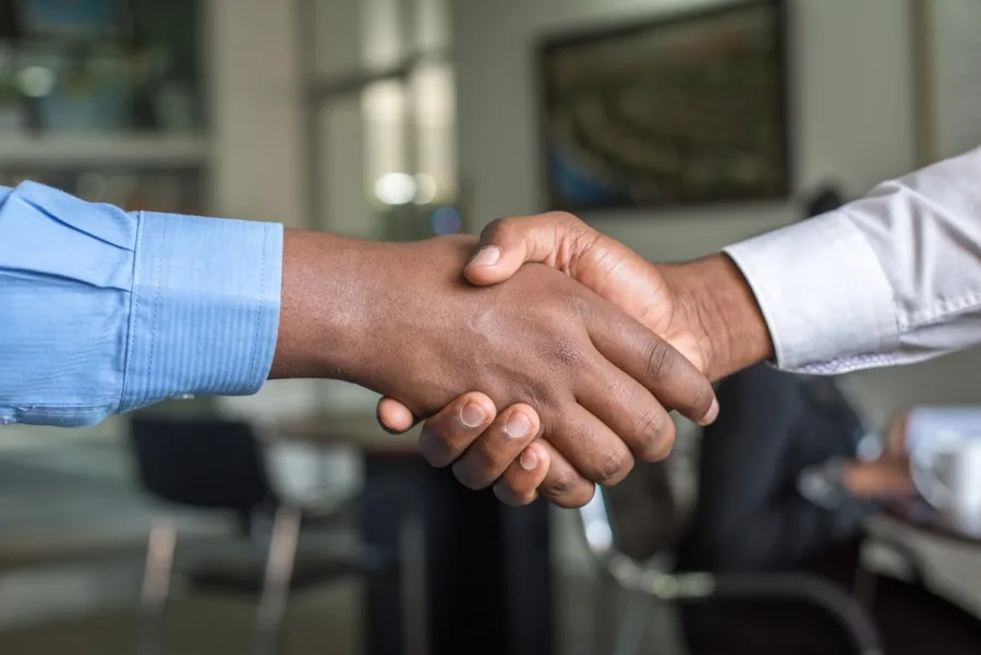 A handshake across an office table
